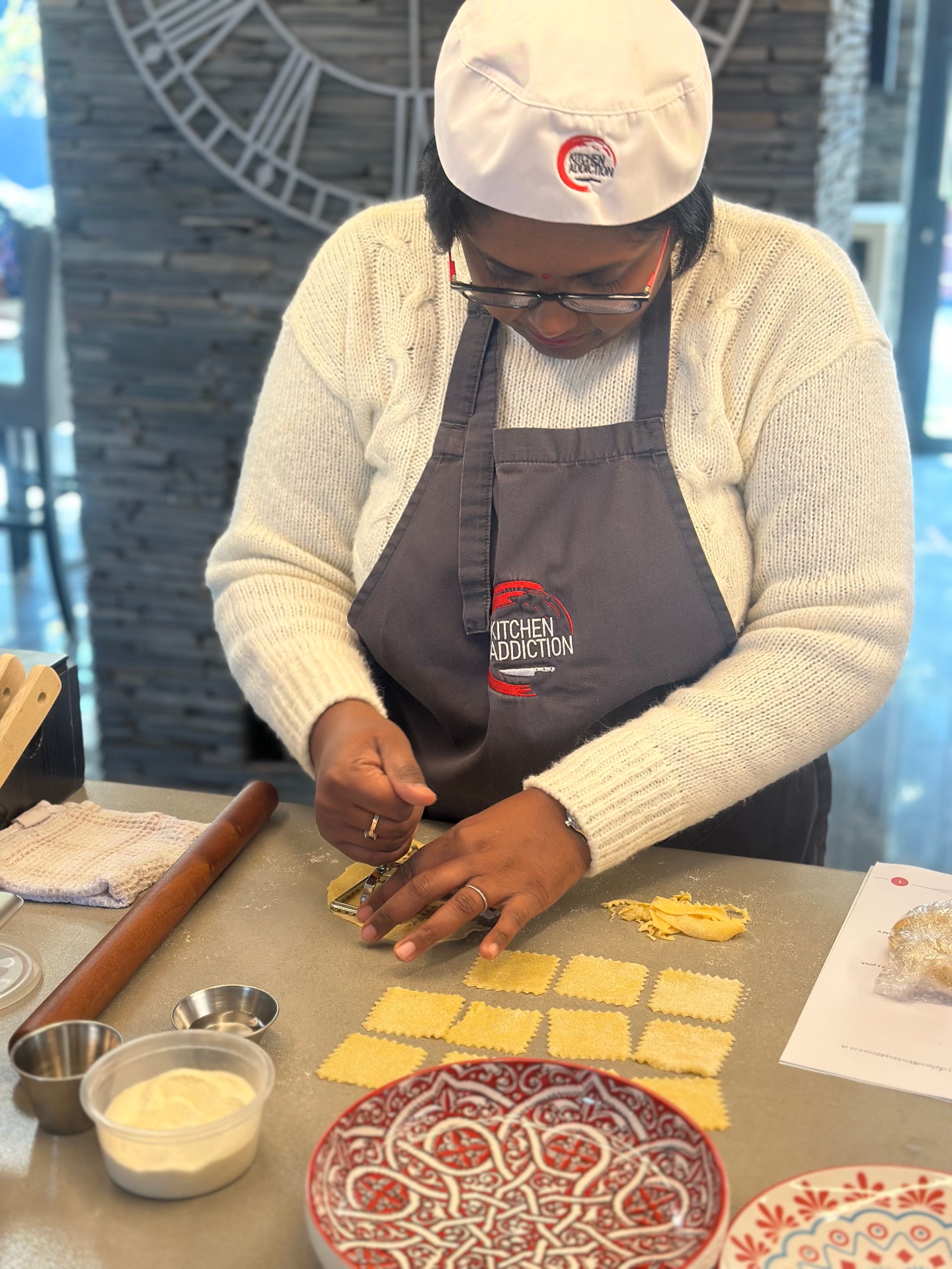 Guests cooking at a Kitchen Addiction class